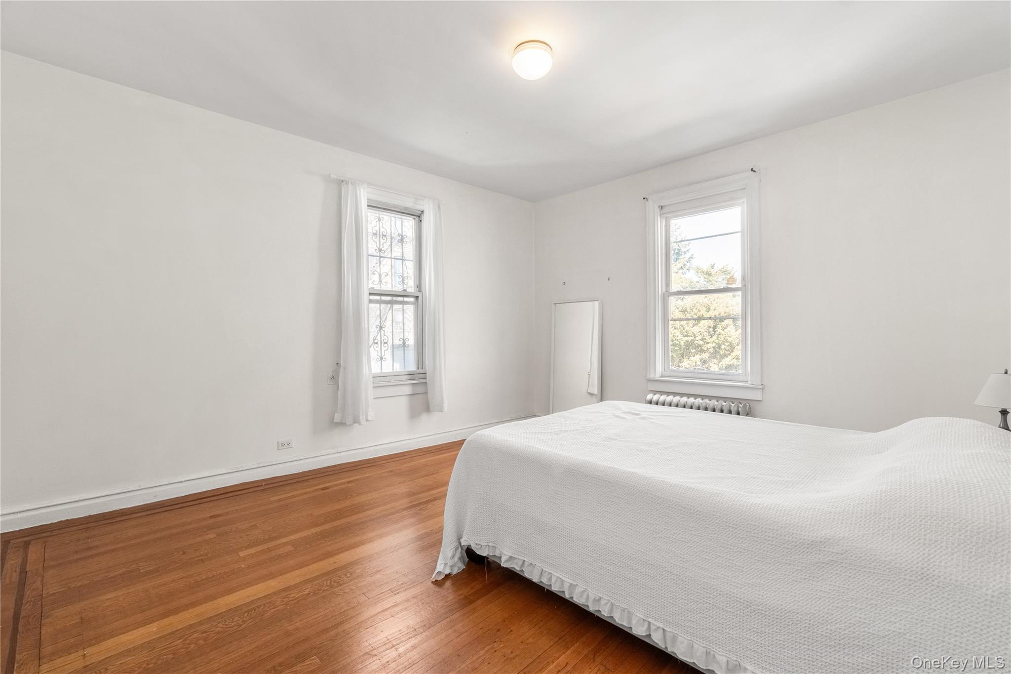 2969 Perry Avenue Bronx, NY 10458 - Photo 16 of 36 a bedroom with a bed and a window