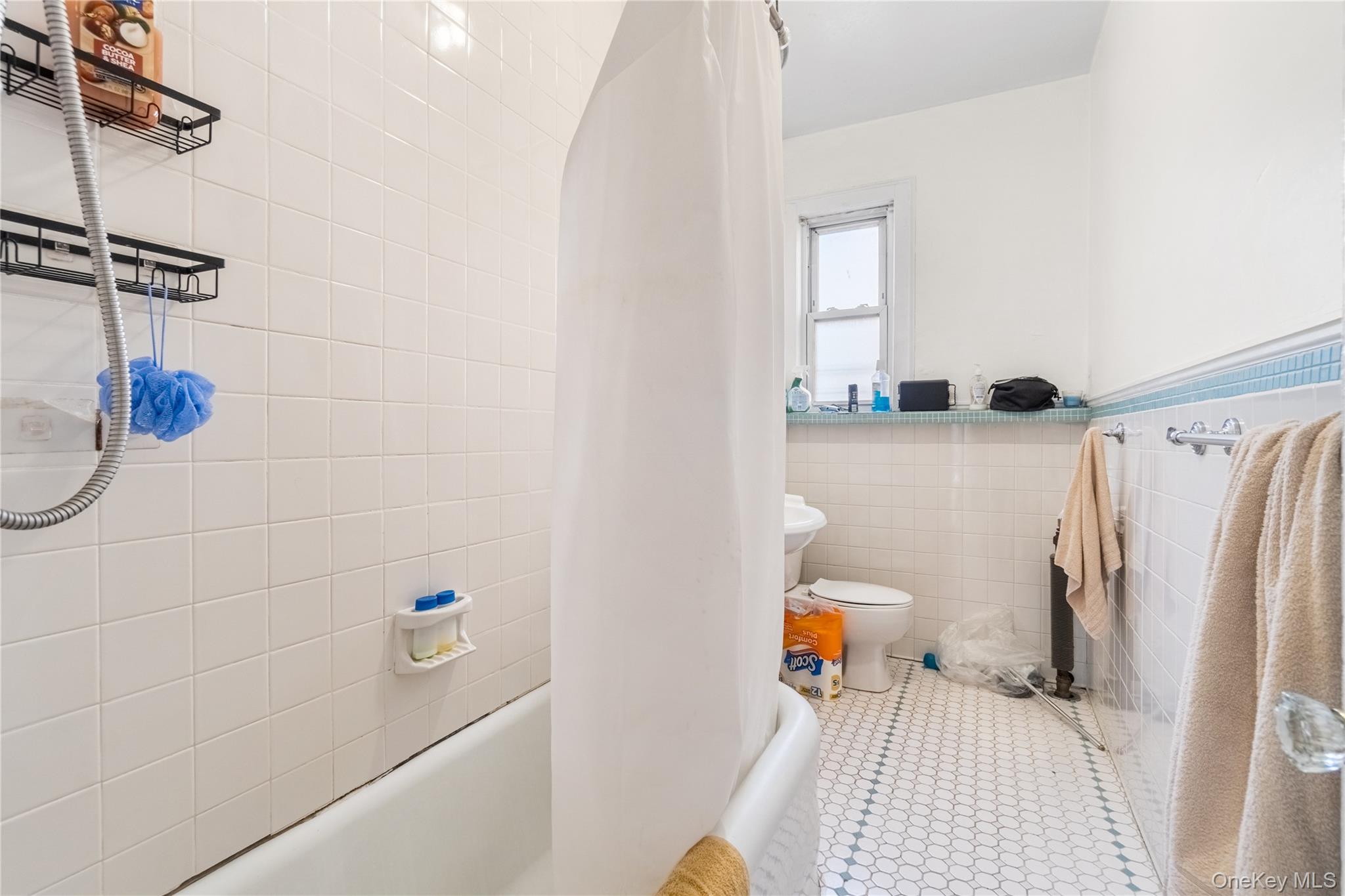 2969 Perry Avenue Bronx, NY 10458 - Photo 17 of 36 a bathroom with a sink a toilet and shower