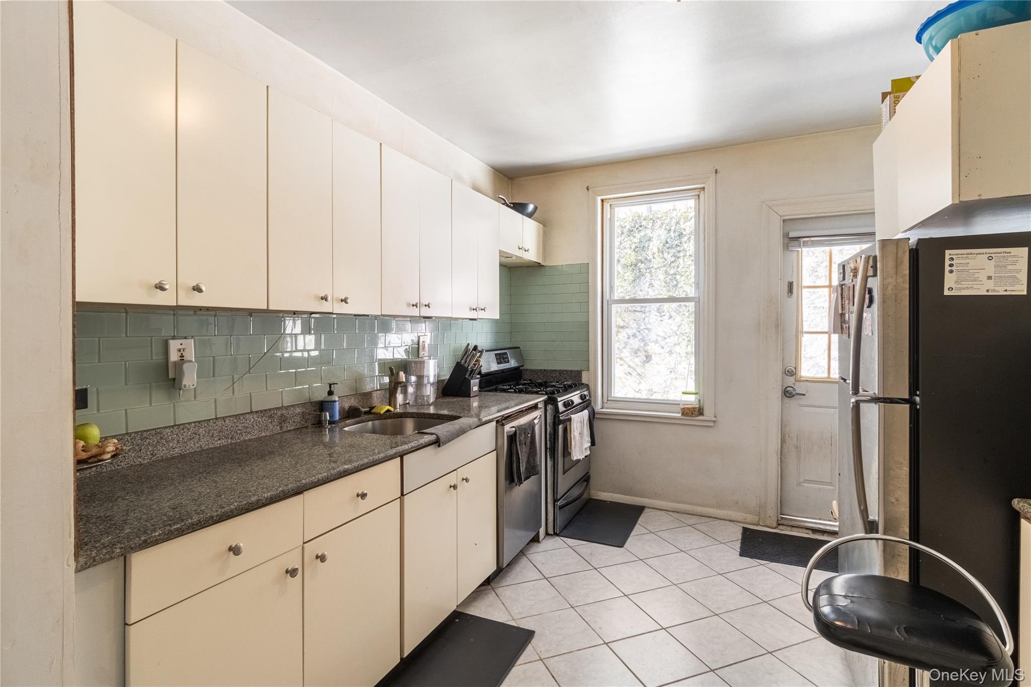 2969 Perry Avenue Bronx, NY 10458 - Photo 21 of 36 a kitchen with a sink cabinets and stainless steel appliances