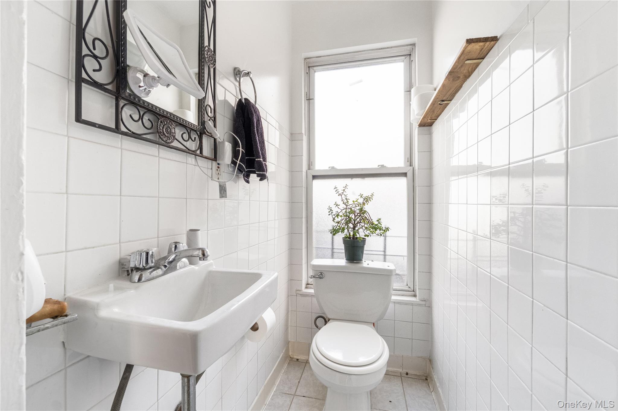 2969 Perry Avenue Bronx, NY 10458 - Photo 22 of 36 a bathroom with a sink toilet and shower