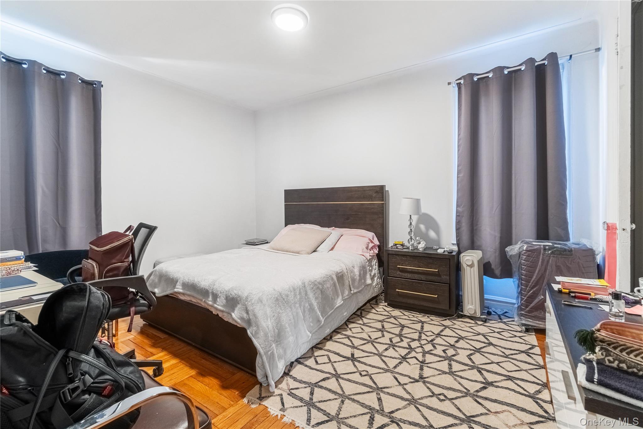 2969 Perry Avenue Bronx, NY 10458 - Photo 23 of 36 a bedroom with a bed and wooden floor