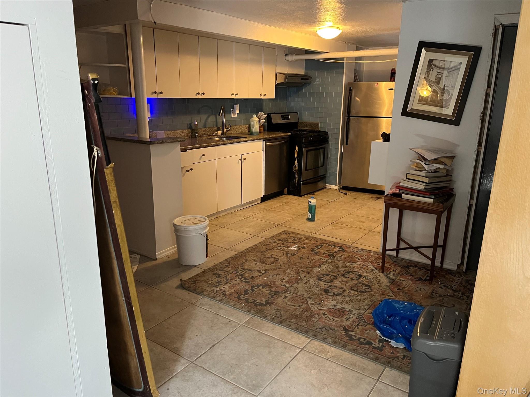 2969 Perry Avenue Bronx, NY 10458 - Photo 34 of 36 a kitchen with stainless steel appliances granite countertop a refrigerator and a stove