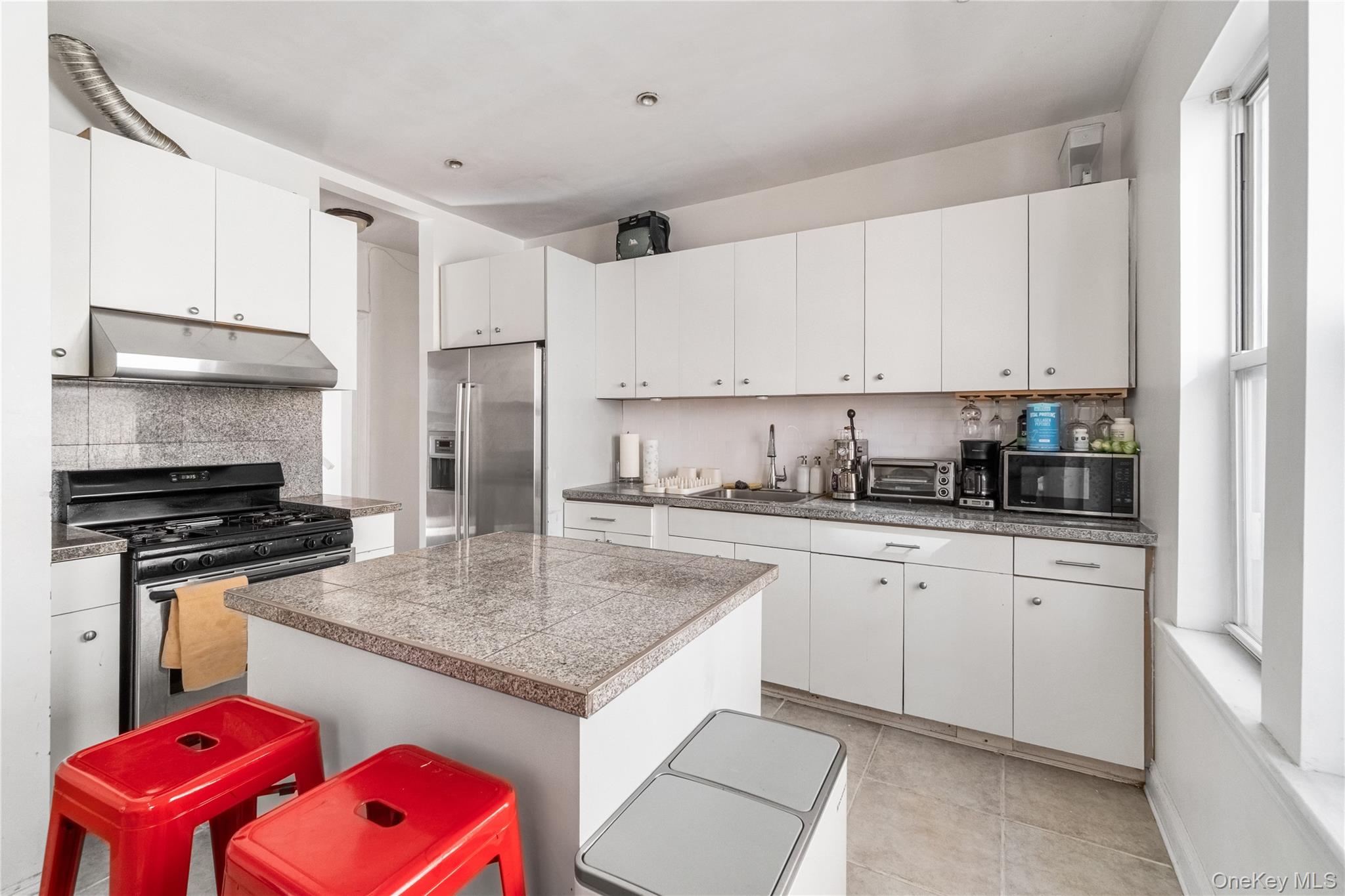 2969 Perry Avenue Bronx, NY 10458 - Photo 6 of 36 a kitchen with stainless steel appliances granite countertop a stove refrigerator sink and cabinets
