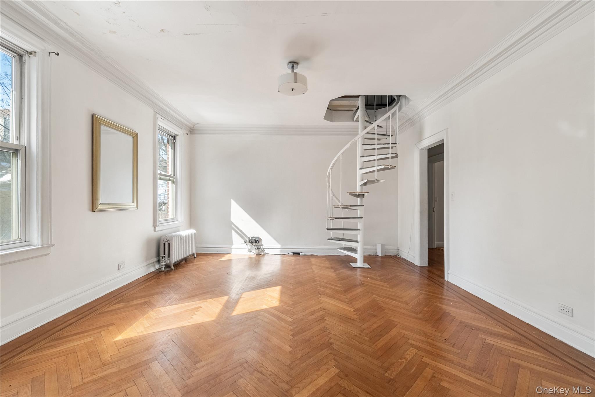 2969 Perry Avenue Bronx, NY 10458 - Photo 10 of 36 a view of an empty room with stairs and a window