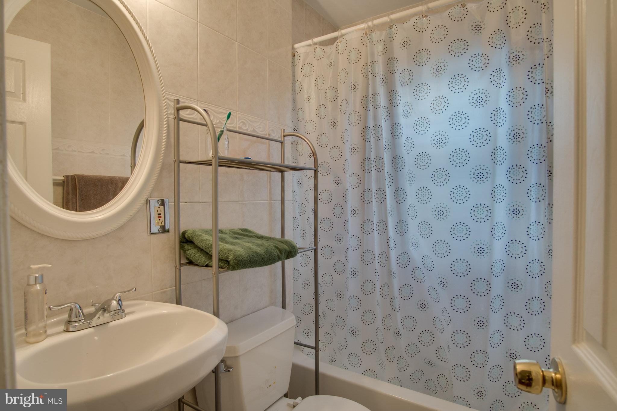 643 Brandywine Street Southeast Washington, DC 20032 - Photo 22 of 26 a bathroom with a sink and a mirror