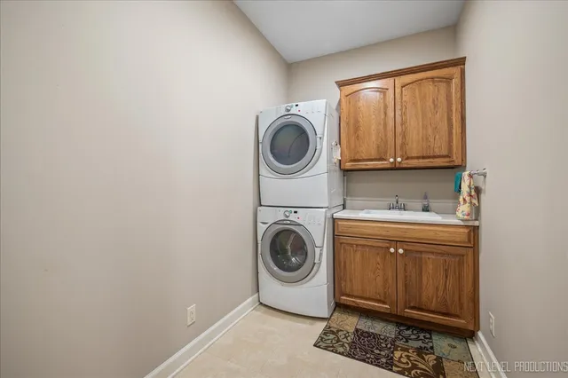 a utility room with sink dryer and washer