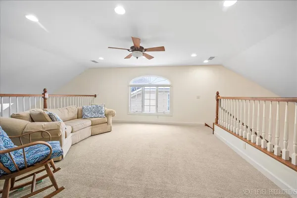 a view of a livingroom with furniture and a ceiling fan