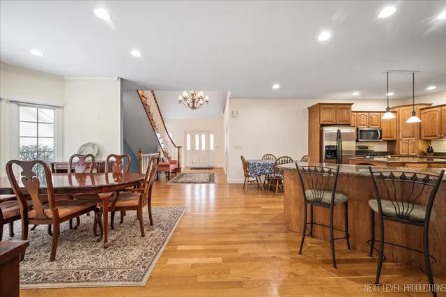 a dining room with lots of furniture and wooden floor