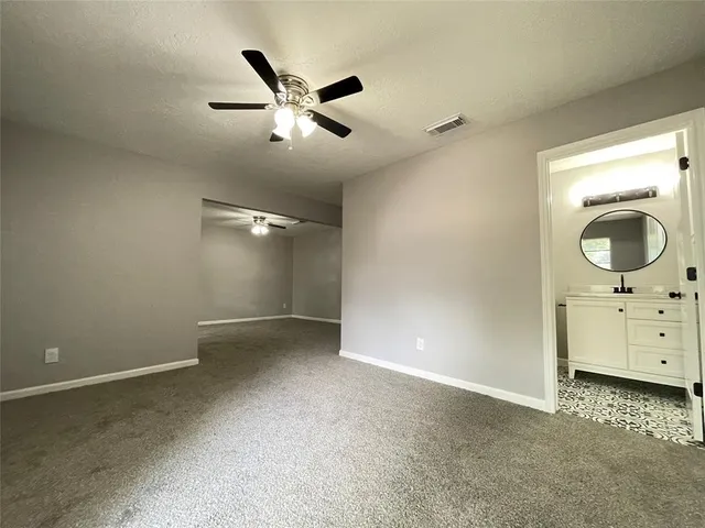 an empty room with mirror on the wall