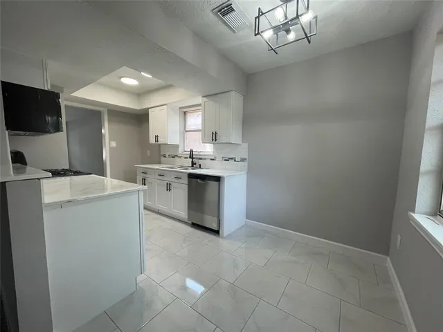a kitchen with a stove a sink and a refrigerator