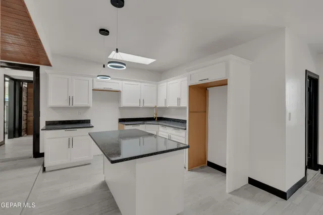 a kitchen with granite countertop a sink and stainless steel appliances