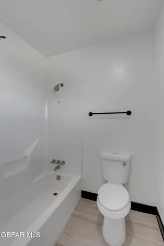a bathroom with a toilet and a bathtub