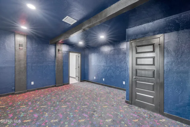 a view of an empty room and a bathroom