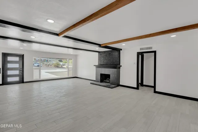 a view of an empty room with a fireplace