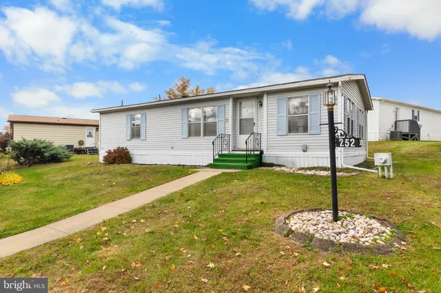 a backyard of a house with swimming pool table and chairs