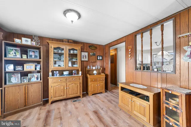 a kitchen with stainless steel appliances granite countertop a stove top oven a refrigerator cabinets and wooden floor