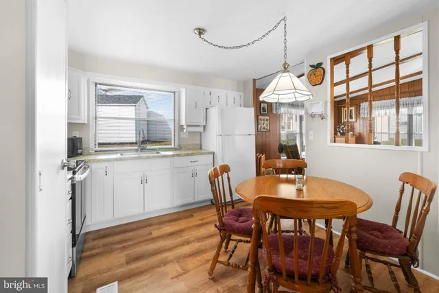 a view of a dining room with furniture and window