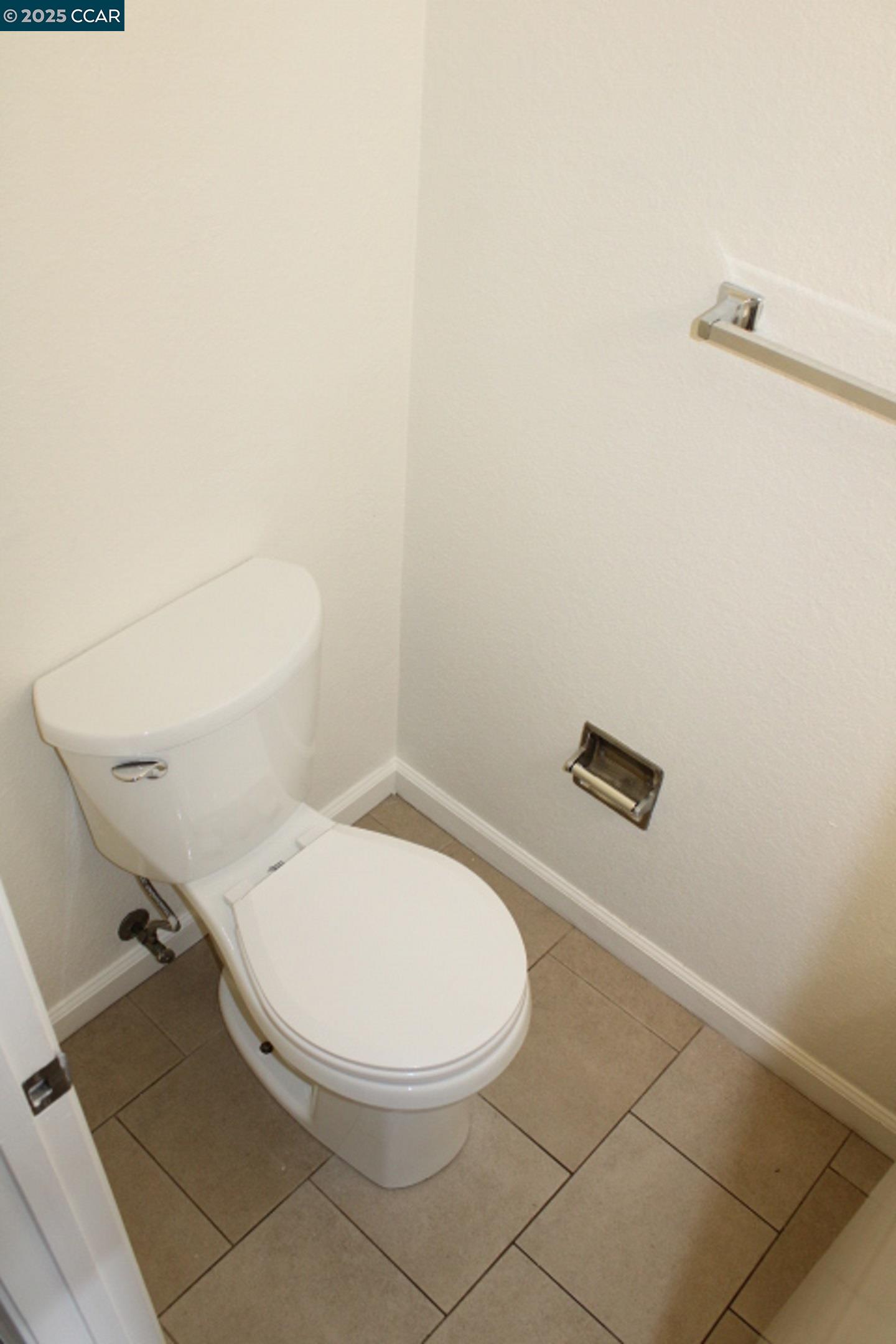 4811 Appian Way, Unit 3/5 El Sobrante, CA 94803 - Photo 12 of 27 a white toilet sitting next to a white wall