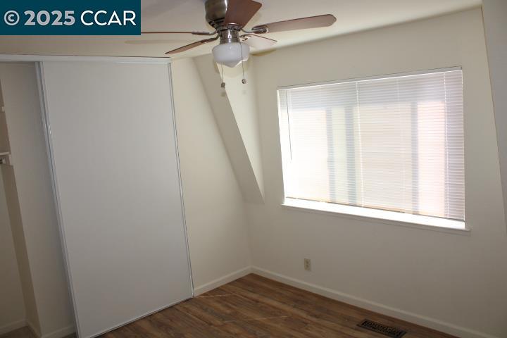 4811 Appian Way, Unit 3/5 El Sobrante, CA 94803 - Photo 15 of 27 a view of a room with wooden floor and fan