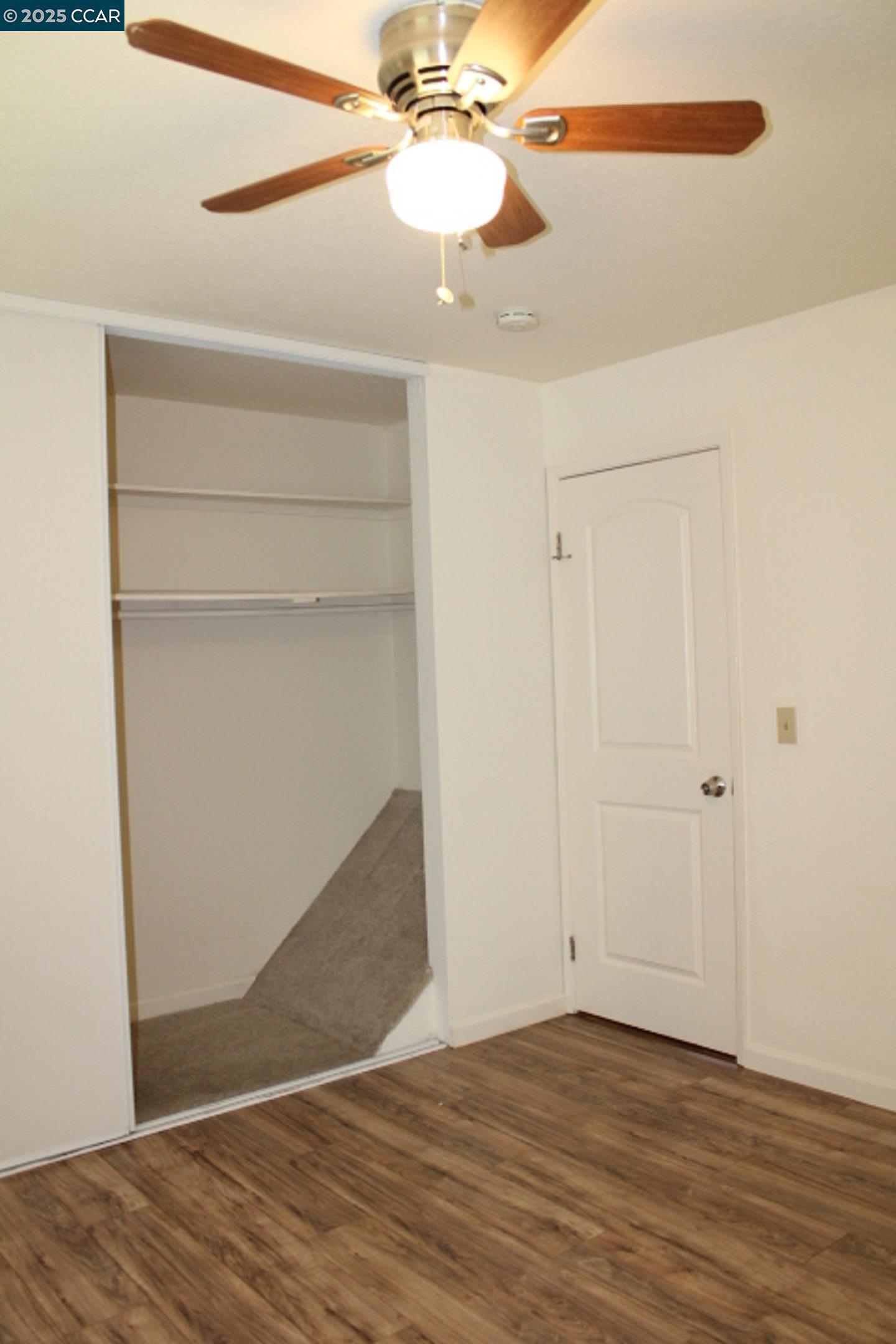 4811 Appian Way, Unit 3/5 El Sobrante, CA 94803 - Photo 19 of 27 a view of an empty room with wooden floor