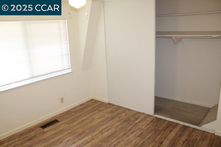 4811 Appian Way, Unit 3/5 El Sobrante, CA 94803 - Photo 20 of 27 a view of a small space with wooden floor and a window