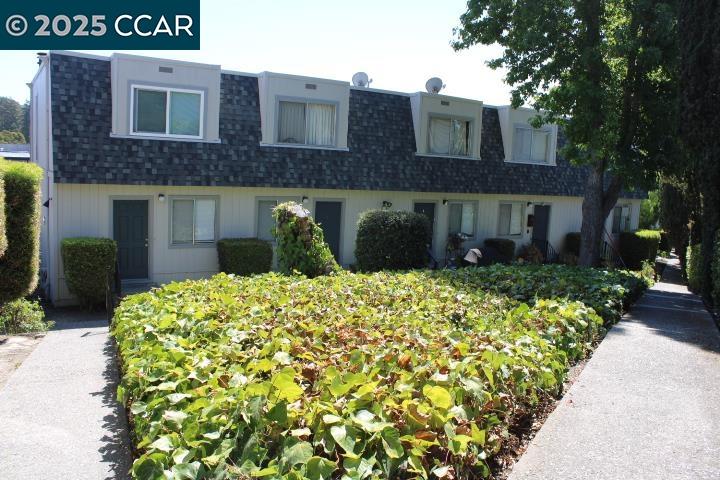 4811 Appian Way, Unit 3/5 El Sobrante, CA 94803 - Photo 25 of 27 a front view of a house with a garden