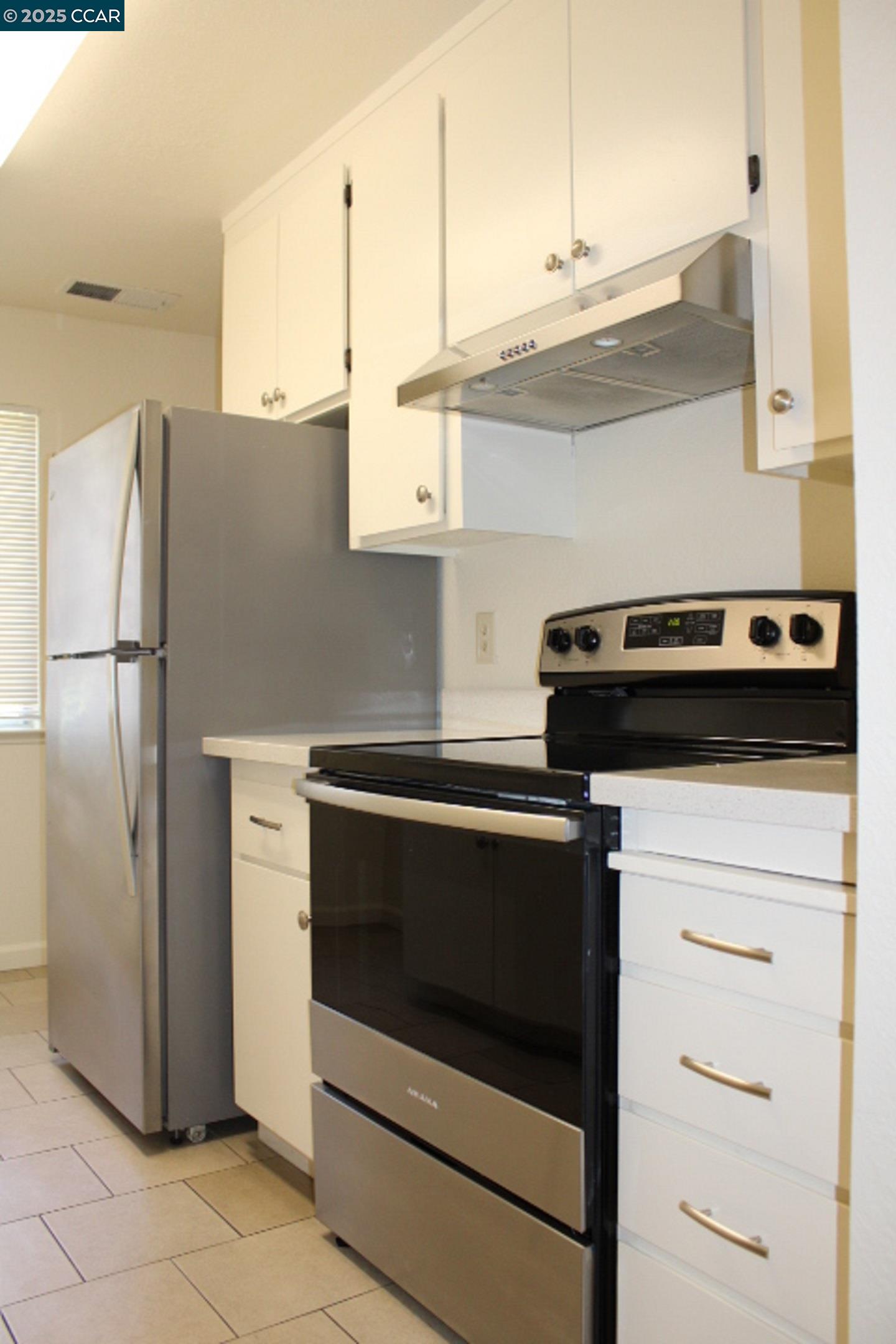 4811 Appian Way, Unit 3/5 El Sobrante, CA 94803 - Photo 9 of 27 a kitchen with stainless steel appliances a refrigerator stove and cabinets
