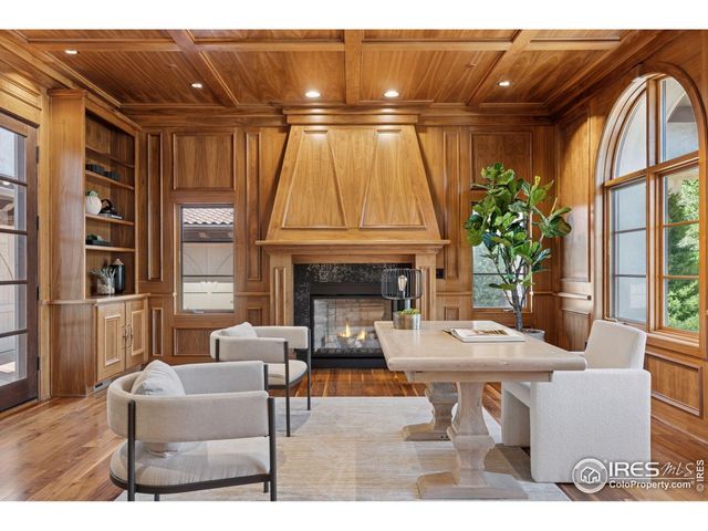 a living room with furniture a wooden floor and a fireplace
