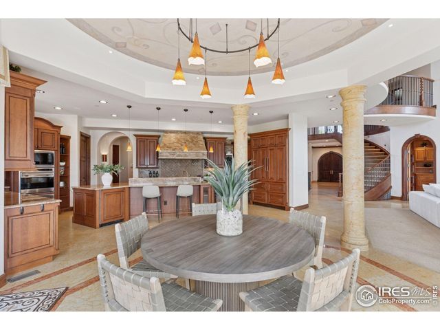 a kitchen with stainless steel appliances granite countertop a stove a sink dishwasher and cabinets with wooden floor