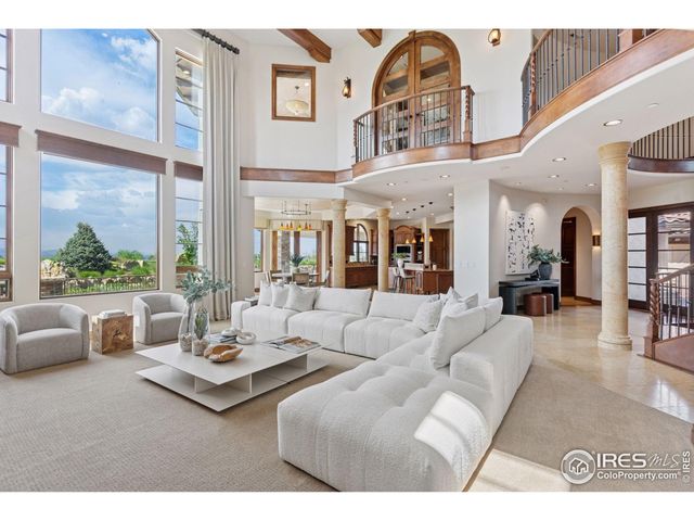 a living room with furniture and a floor to ceiling window