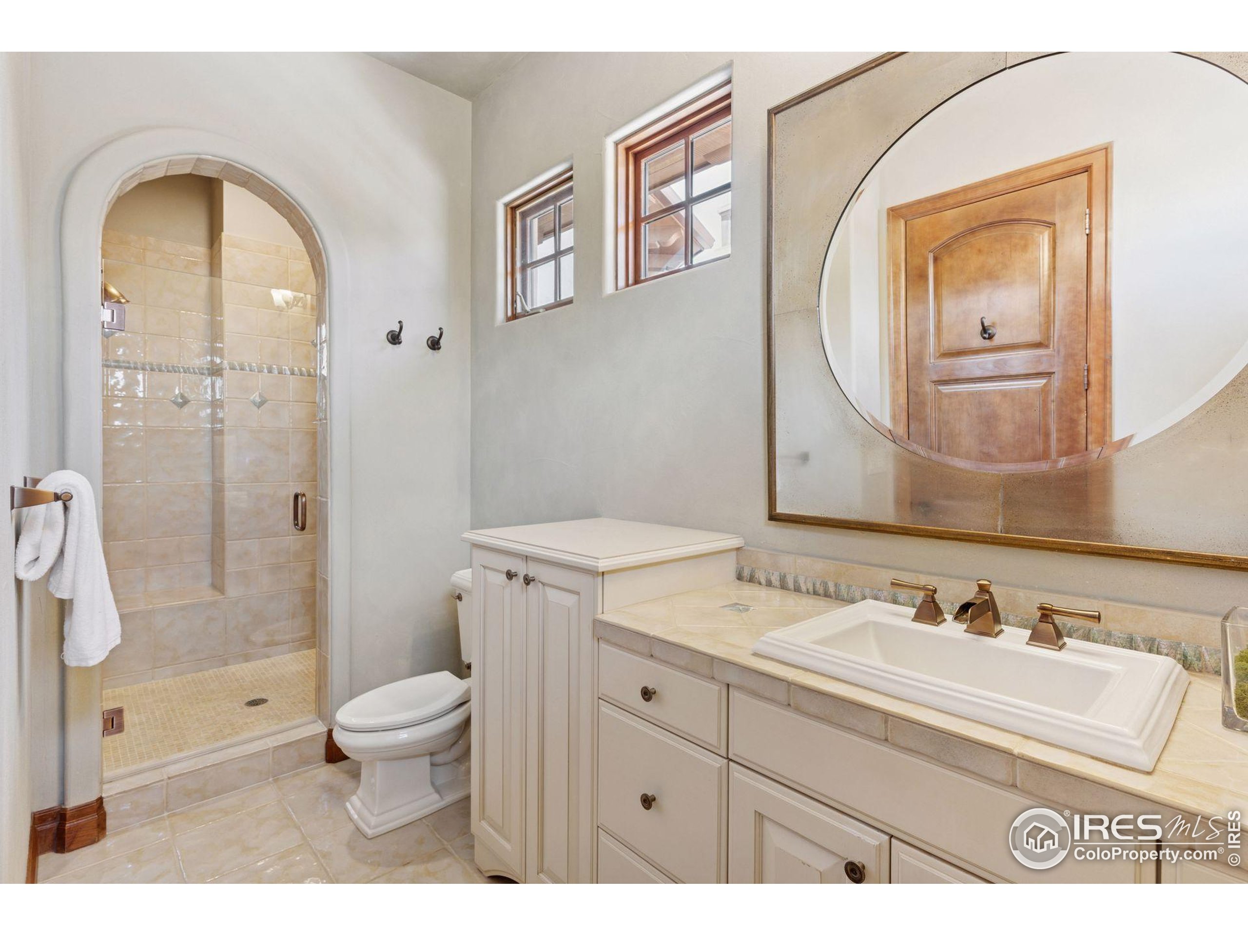 6541 Legend Ridge Trail Niwot, CO 80503 - Photo 32 of 45 a bathroom with a sink a toilet and shower