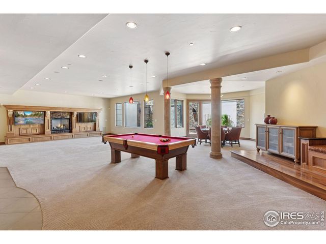 a living room with furniture a large window and dresser