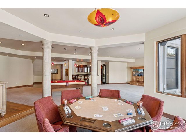 a living room with furniture a table and kitchen view