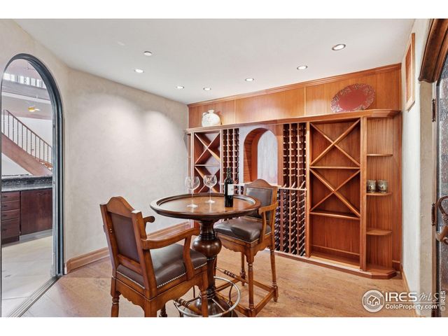 a living room with furniture a table and kitchen view