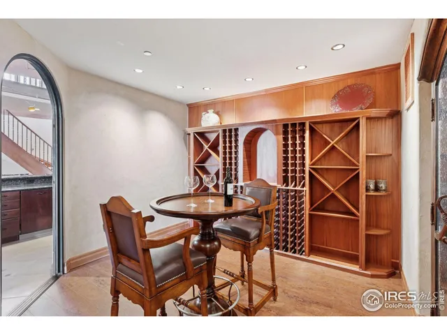 a living room with furniture a table and kitchen view