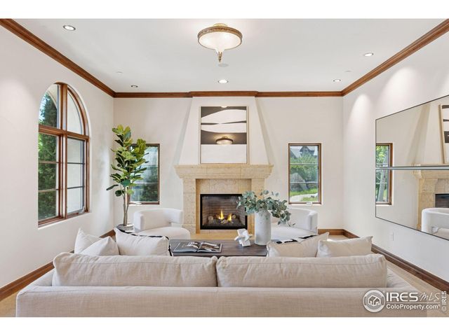 a living room with furniture fireplace and window