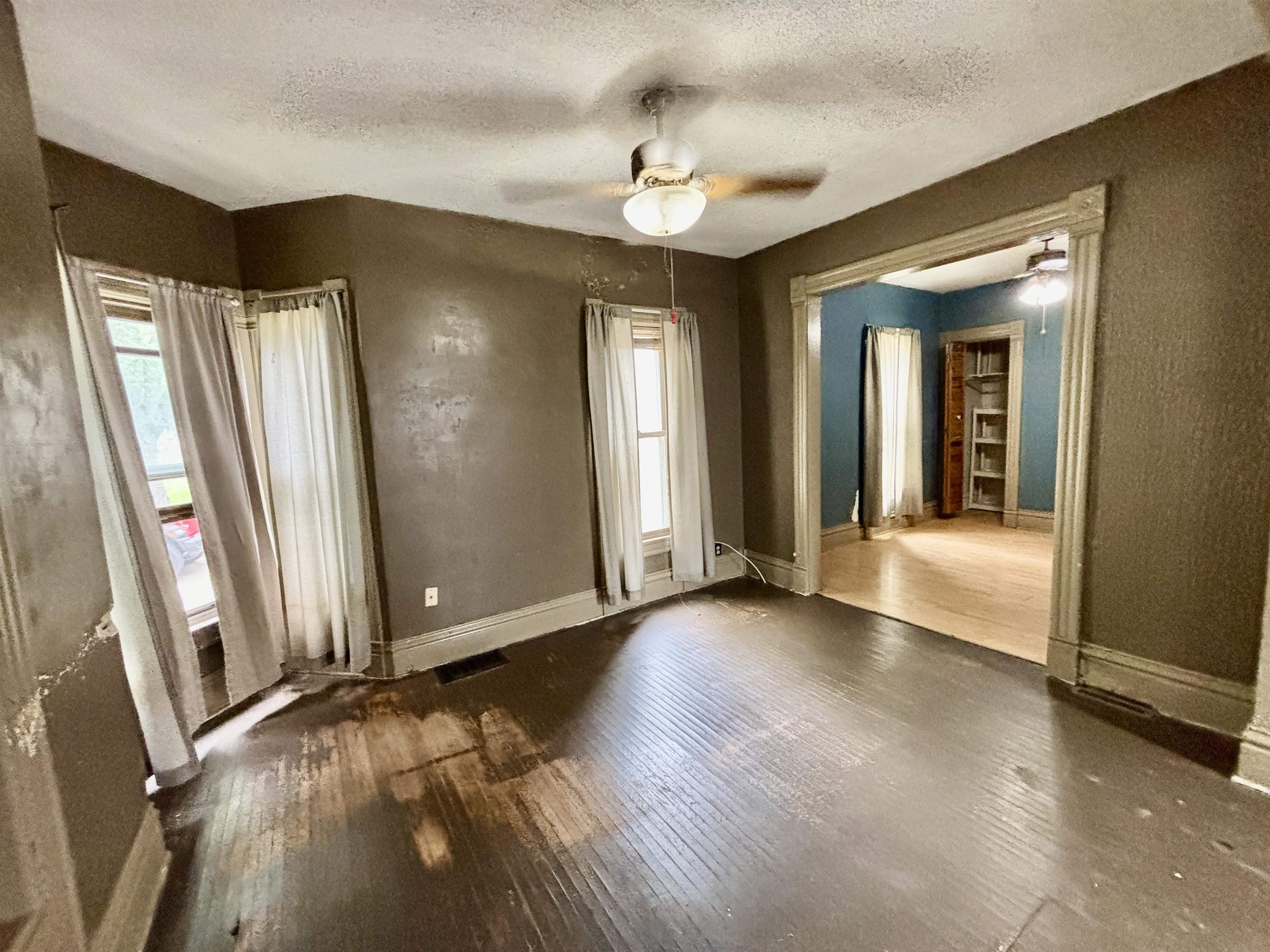 412 West Madison Street Belvidere, IL 61008 - Photo 7 of 27 an empty room with wooden floor and windows