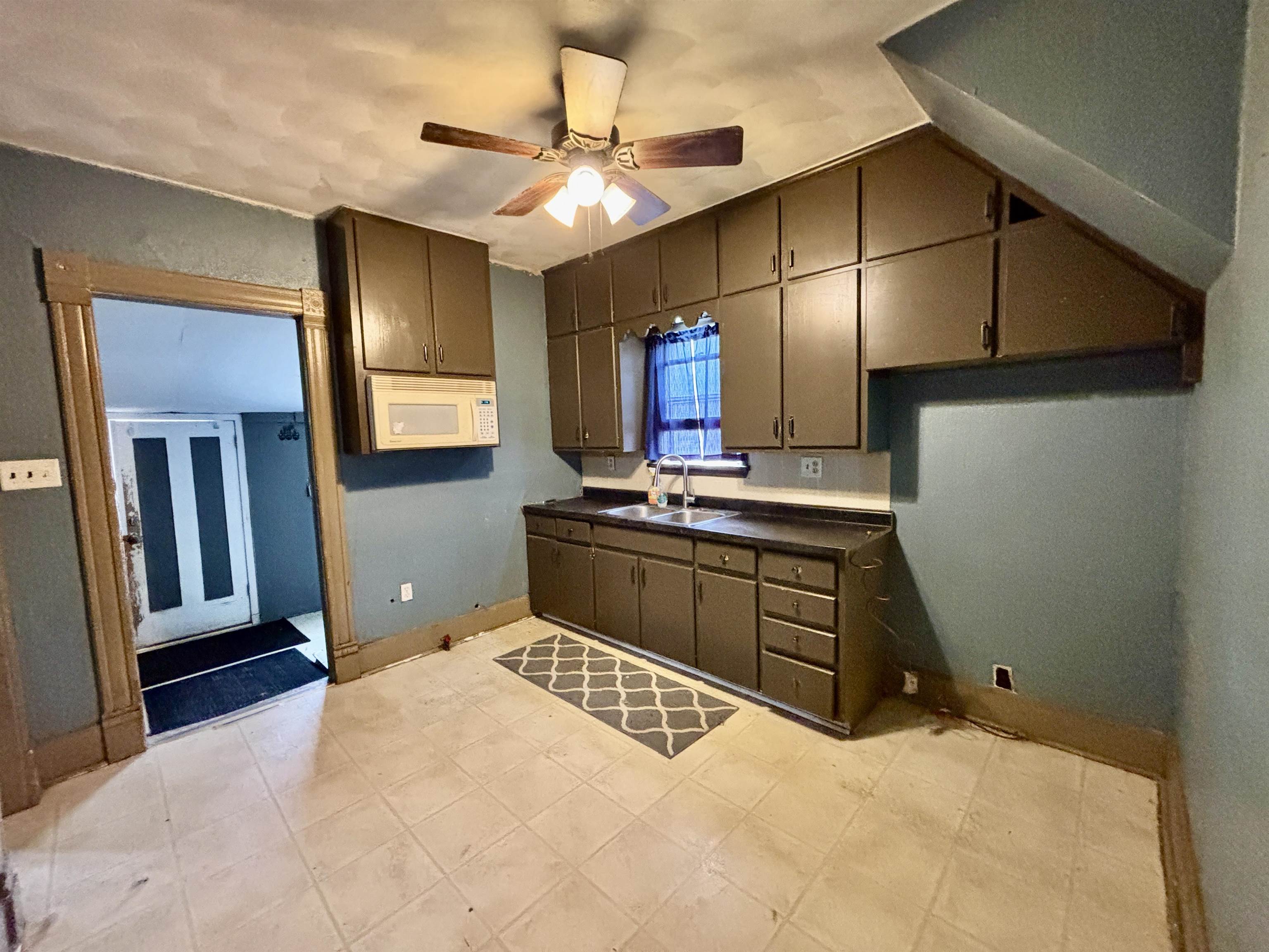 412 West Madison Street Belvidere, IL 61008 - Photo 8 of 27 a kitchen with a stove a refrigerator and a sink