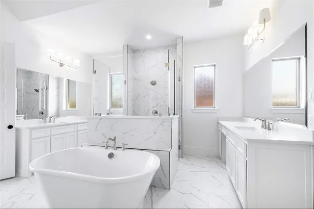 a bathroom with a bathtub sink double and mirror