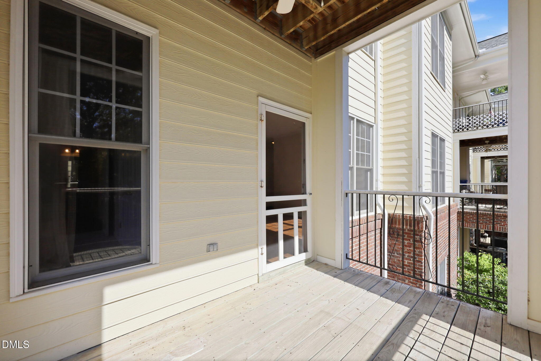 801 Moratuck Drive, Unit 202 Raleigh, NC 27604 - Photo 21 of 23 a view of a balcony with wooden floor and fence