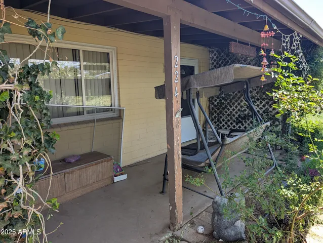 a living room with furniture a flat screen tv and a gym