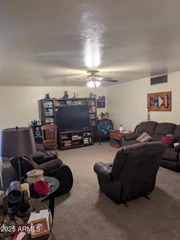 a living room with furniture a rug and a chandelier