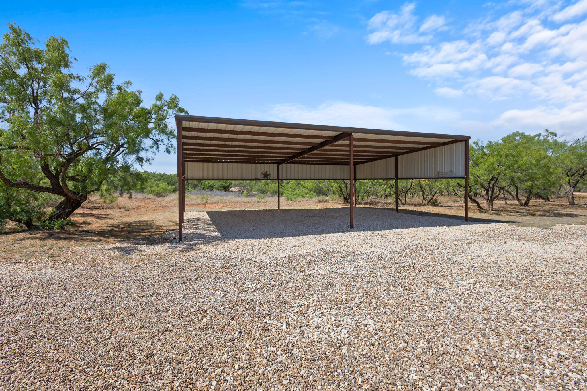 301 Fagan Road Snyder, TX 79549 - Photo 14 of 102 a view of a street with a bench in the patio