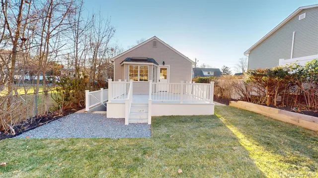 a view of an house with backyard and trees