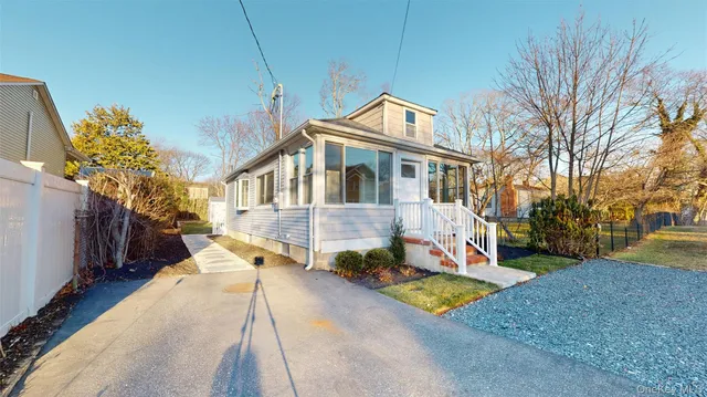 a front view of a house with a yard tree s