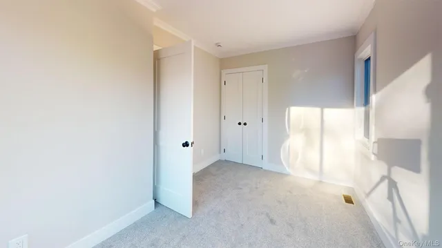 a view of an empty room and a window