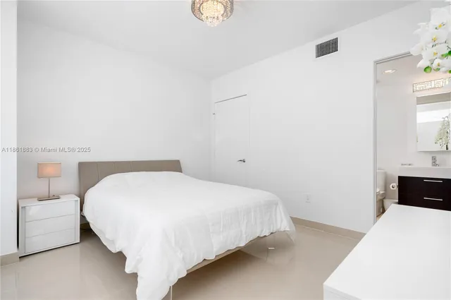 a large white bed in a white room
