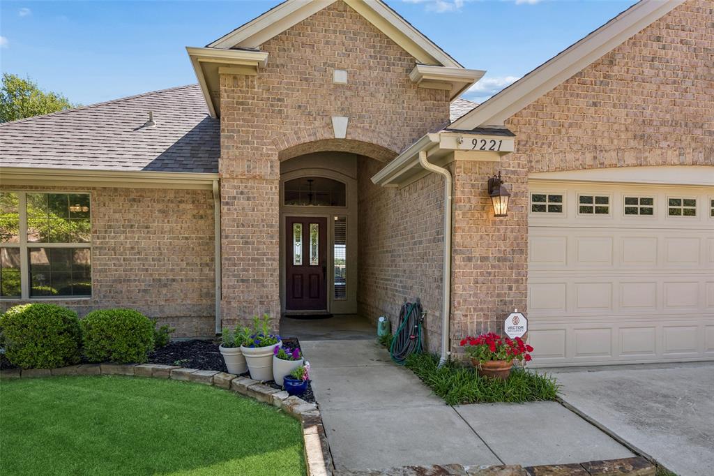 9221 Perimeter Street Denton, TX 76207 - Photo 3 of 36 a front view of a house with a garden