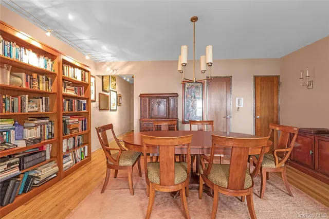 a view of a dining room with furniture and a book shelf