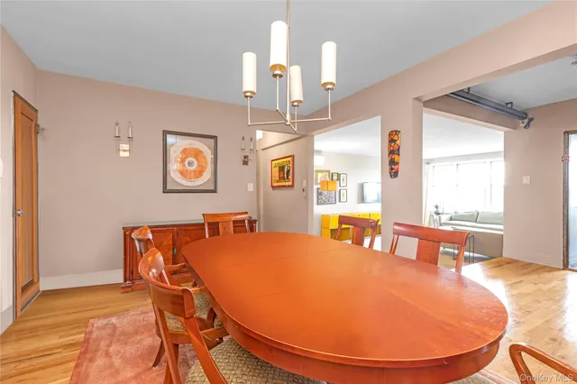 a dining room with a table chairs and a chandelier